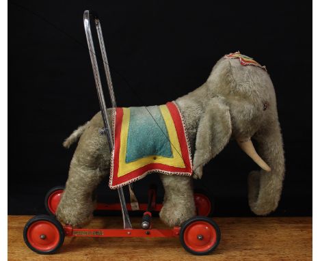 A 1950's Merrythought Toys novelty push along/ride on 'Nellie' Elephant on wheels, from the 'Safety Toddle Toys' range, grey 