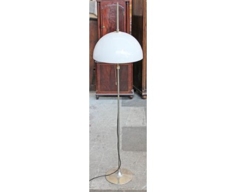 A 1970s standard lamp having white plastic shade and aluminium tulip base. H152cm.