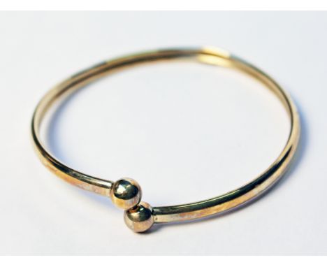 A 9ct gold bangle, wt. 3.6g.