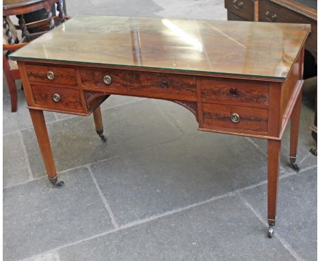 A 19th Century mahogany desk having square tapered legs with brass casters, the middle drawer stamped 'SE & R JOHNSON WARRING