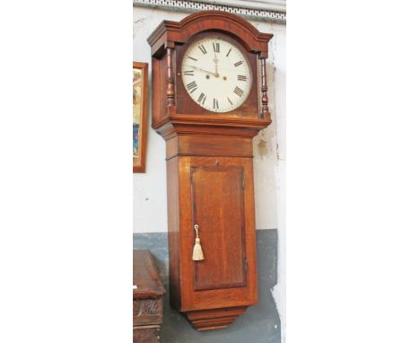 A 19th Century 8 day oak tavern clock. Diam. 35cm H143cm.Condition: The glass has been replaced at some point. There are a co