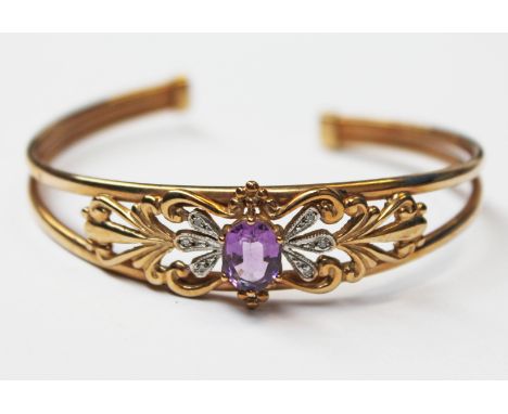 A 9ct gold diamond and purple stone bangle, diam. 6cm, gross wt. 10.4g.