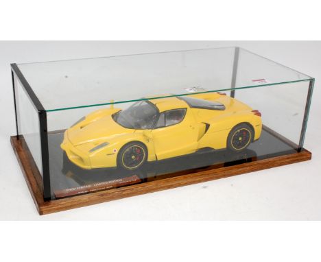 A well made 1/12th scale model of a Ferrari Enzo, finished in yellow, made from a Tamiya kit with added detail, in a glass di