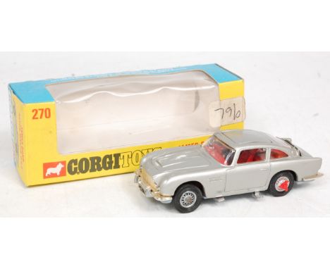 Corgi Toys, 270, James Bond's Aston Martin DB5, silver body, red interior, revolving number plates and extending tyre slashes