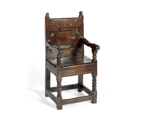 Walnut child's Wainscot armchair 17th Century, mouldings to the back, bobbin turnings to the arms and front legs, 84cm high x