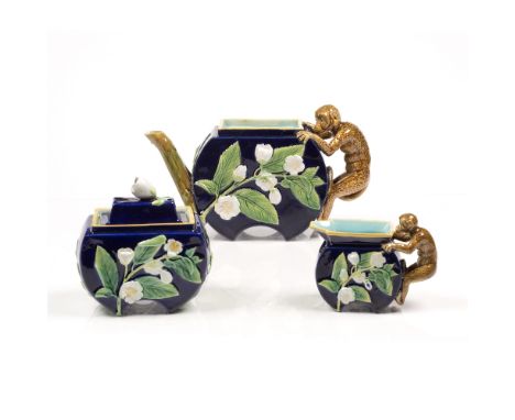 George Jones  Majolica teapot, milk jug and sugar bowl, late 19th century, decorated with white blossom on cobalt ground, han