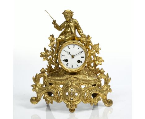 French gilt metal mantel clock with striking movement under a glass dome, 33cm high