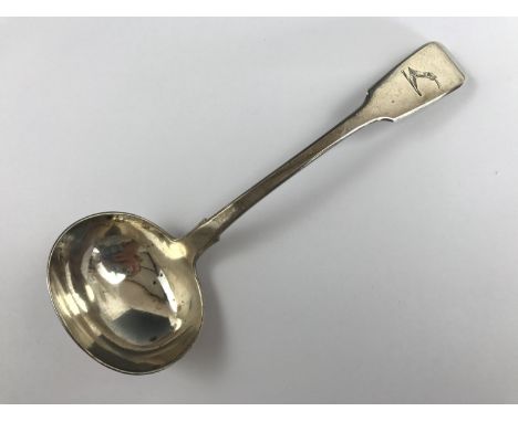 A Victorian Irish silver fiddle-pattern sauce ladle, the terminal engraved with an armorial crest in the form of an armoured 