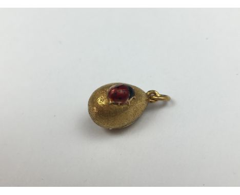 A high-carat yellow-metal, diamond and ruby egg form pendant, possibly by Faberge, having a naturalistically modelled and bas