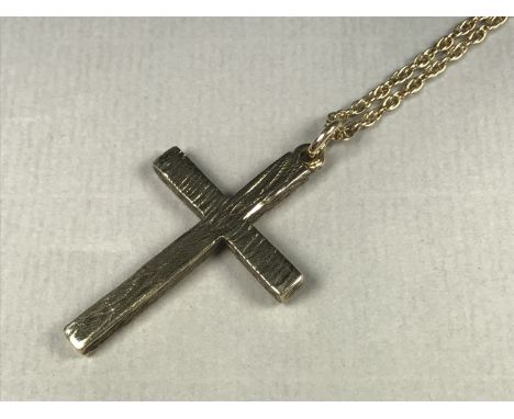 A heavy yellow-metal bark-effect cruciform pendant, suspended on a fancy-link yellow-metal neck chain, latter stamped '9ct', 