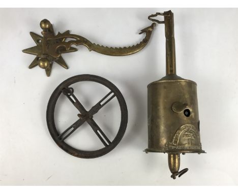 A 19th Century brass spit-jack manufactured by John Linwood, together with a decorative bracket, the latter terminating in a 
