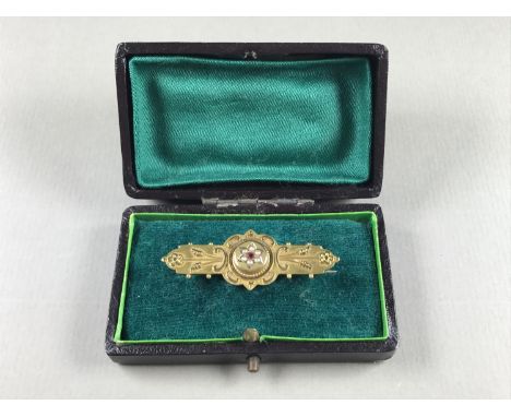 A Victorian Etruscan Revival 9ct gold bar brooch, having a central almandine garnet and split seed-pearl flower-head cluster,