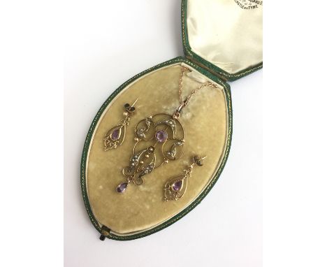 A Belle Epoque amethyst and pearl demi-parure, comprising pendant necklace and earrings, in an openwork arrangement surmounte