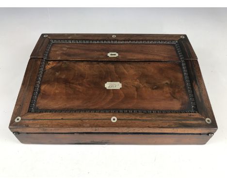 A Victorian mahogany writing slope, having white-metal stringing and mother of pearl inlay, opening to reveal a fitted interi