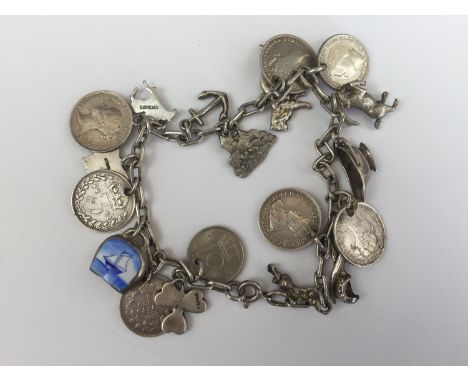 A vintage white-metal charm bracelet and charms, including a Connemara marble clover, and Victorian three-penny pieces, 32g