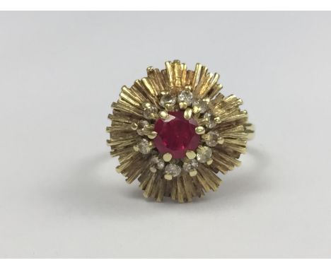 A late 1960s Verneuil ruby and diamond cocktail ring, having a central round-cut ruby of approximately 1ct, framed by pellet-