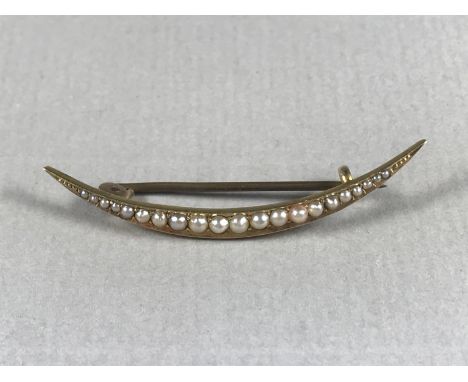An Edwardian seed pearl brooch modelled in the form of a crescent moon, on high-carat yellow-metal, tests as high carat gold,