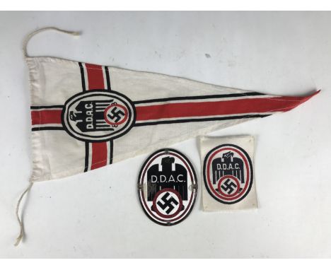 A group of German Third Reich DDAC, Deutscher Damen Automobil Club insignia comprising a pennant, enamel car badge and woven 