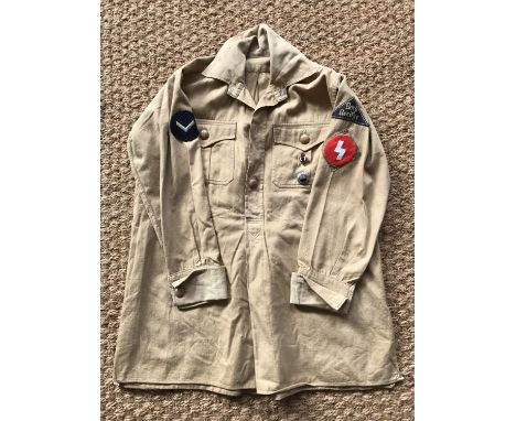 A Hitler Youth service shirt bearing Nord Nordsee district badge, Oberbann 1 and DJ-Hordenfuhrer rank patches, Deutsche Arbei