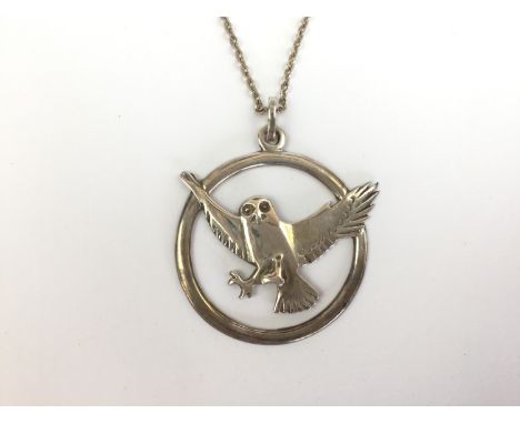 An Ola M Gorie (20th Century) silver pendant necklace, modelled in the form of a swooping owl foiled against an annulus, Edin