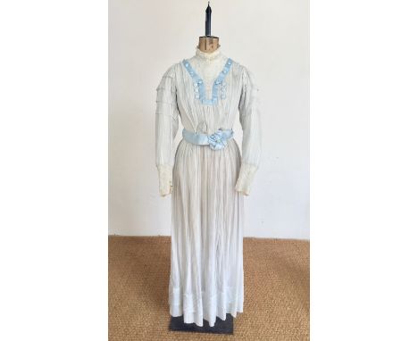 An early 20th Century lady's muslin and powder-blue satin tea dress, of two-piece construction, having a long-sleeved pouter-