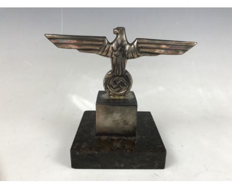 A German Third Reich electroplate and marble desk ornament, in the form of an army eagle on plinth bearing the inscription 5 