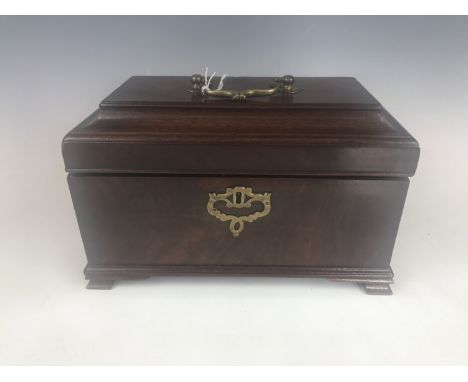 A Georgian mahogany tea caddy, having brass bale handle and key escutcheon, raised over bracket feet, opening to reveal a gre