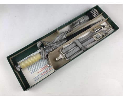 A German Democratic Republic army officer's dagger in original packaging with straps and knot