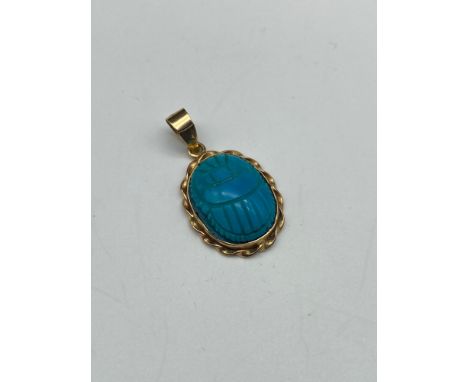 An antique Egyptian revival carved scarab beetle pendant- pendant carved from turquoise stone, gold surround is of a high gra