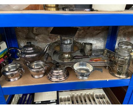 A Shelf of silver plated and E.P wares which includes three piece tea service and claw foot serving tray. 