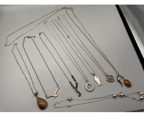 A Lot of 9 silver 925 chains together with various 925 silver pendants. Which includes Pale green jade pendant. 