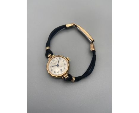 A Vintage 9ct gold 'Excalibur' 17 Jewels Incabloc Non Magnetic Watch. Has a black rope like material strap and rolled gold cl