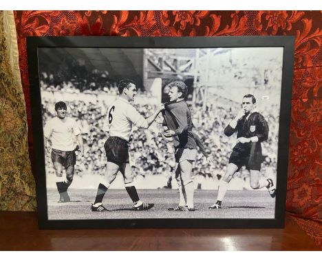 A Vintage framed football poster of two players arguing . [Frame 67x88cm] 