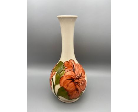 A Vintage Moorcroft vase detailing a tubelined Hibiscus flower design. Impressed to the base and Signed in Green W.M. [21.5CM
