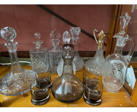 A Lot of vintage and antique cut crystal and glass decanters which includes smoked glass whisky decanter and glasses, Etched 
