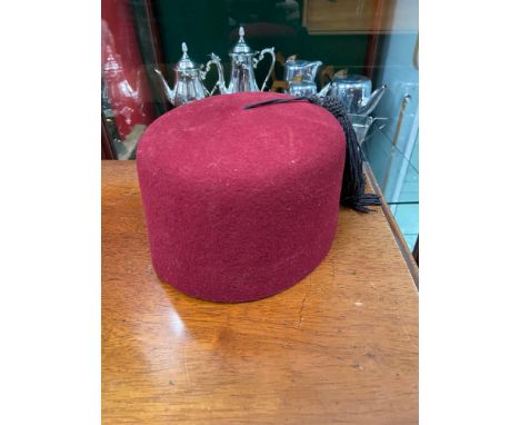 A Vintage red velvet fez hat, Stamped with military marks and dated 1957. Size 6 1/2. 