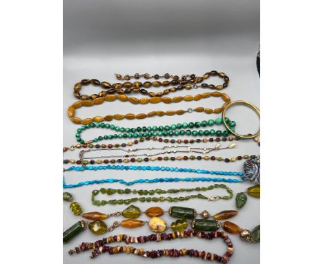 A Quantity of vintage gem stone jewellery which includes tiger eye stone graduating bead necklace with silver catch and clasp