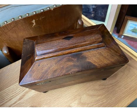 A 19th century Mahogany tea caddy, Supported on bun feet. 