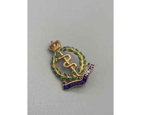 A 9ct gold and enamel Royal Army Medical Corps badge. [5.19 Grams] 
