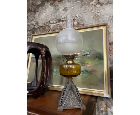 A 19th century cast metal, amber glass and frost glass shade paraffin lamp. 