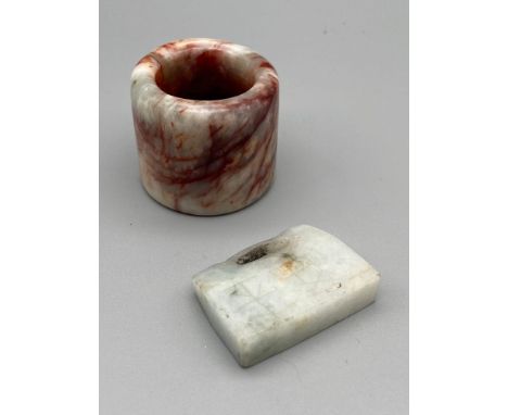 A Chinese jade archers ring together with a pale jade padlock detailed with engraved markings. 