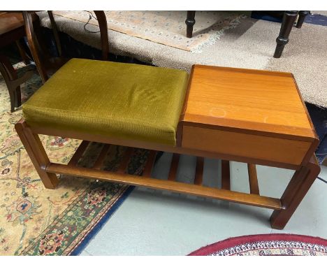 A Mid century teak telephone table with green material cushion seat area. Single pull out drawer and ladder effect under shel