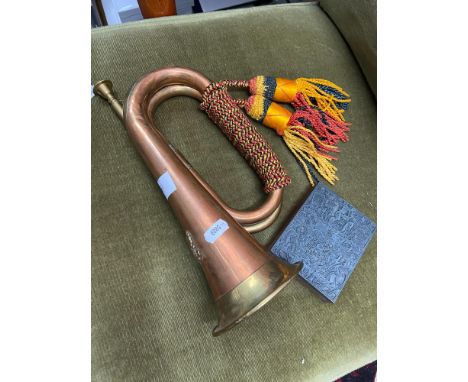 A Military style brass and copper bugle with tassels. Together with a Royalty crest pewter &amp; wooden block print duplicato