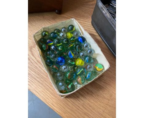 A Box containing a quantity of vintage marbles. 