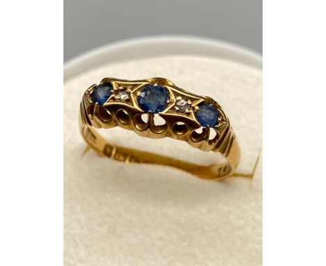 Antique ladies Chester/ Sheffield 18ct gold ring set with three sapphires and two diamonds. Ring size P. [3.02 Grams] 