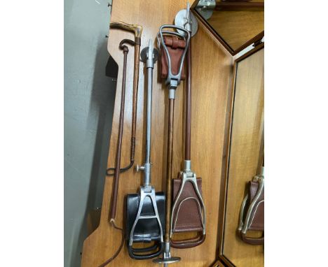 A Lot of three shooting stick stands and two various riding crops. 