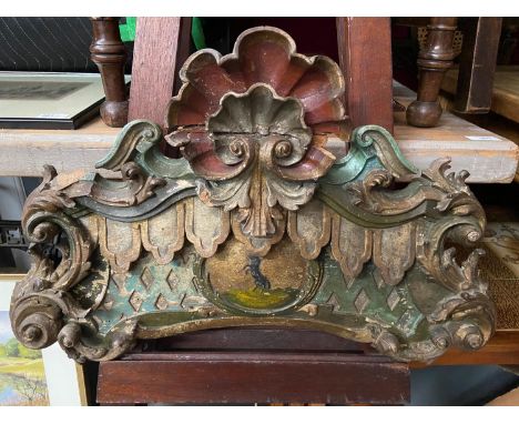 A 17th century hand carved wooden finial panel showing signs of original paint work. Centre panel depicts a hand painted ram 