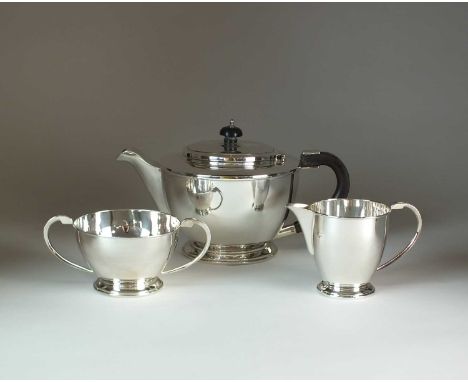 A three piece silver tea service, Sheffield Assay Office, Sheffield 1987, comprising; a teapot with ebonised handle and finia