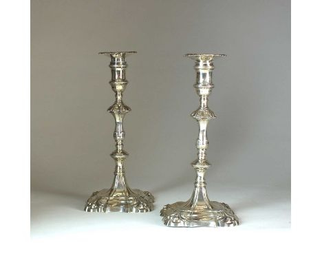 A pair of George II cast silver candlesticks, John Perry, London 1757, each with knopped stem and raised on shaped square bas