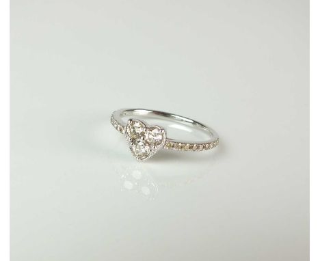 A heart shaped diamond ring, designed as three brilliant cut diamonds claw set in white metal to heart shaped mount with diam